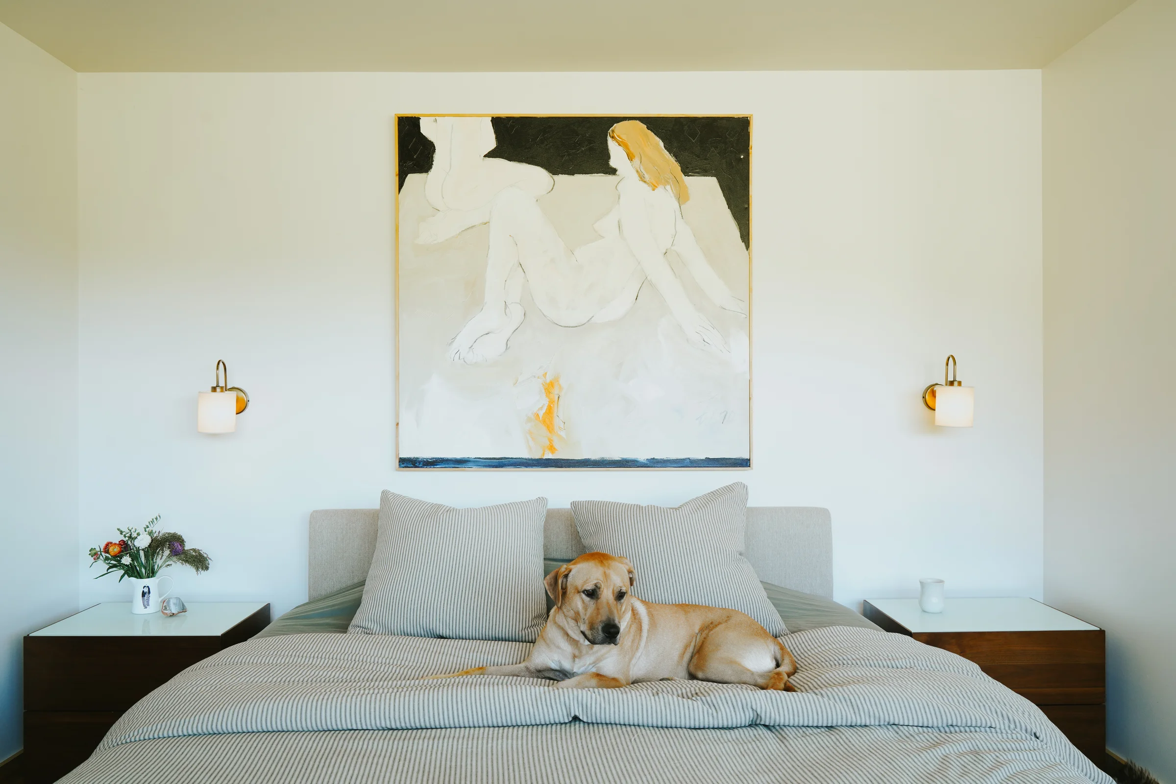 A Freeman W. Butts painting hanging above a bed
